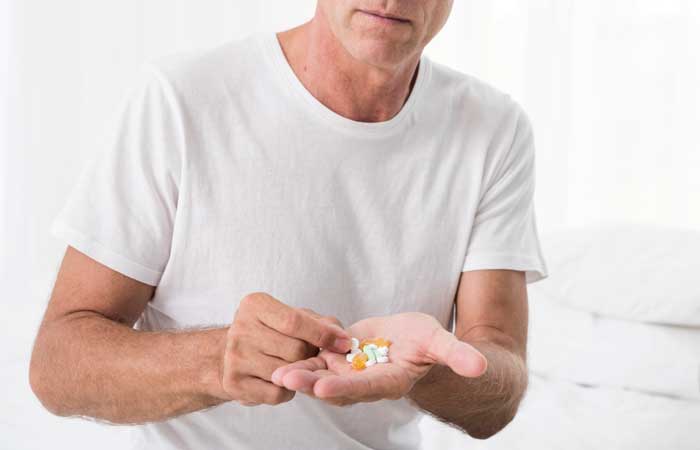 close up man with pills bedroom